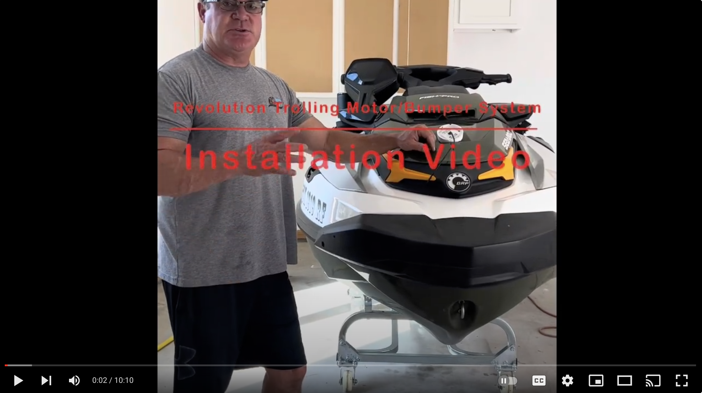 Thumbnail of the Revolution install video; man standing beside a ski craft.